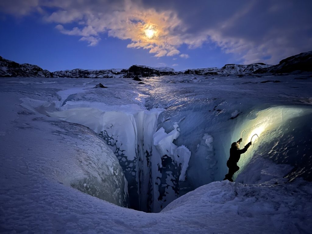 man ice climbing at a glacier in Iceland