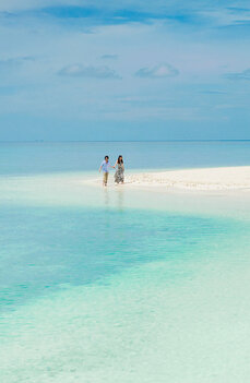 Honeymoon couple Maldives Honeymoon couple on a sandbar in the Maldives